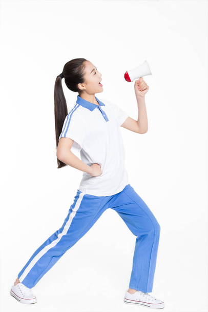 chinese female students wearing short-sleeved uniform, holding a loudspeaker shouting - Foto, Bild