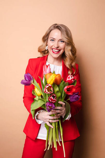 Portrait of beautiful fashion woman posing with colorful tulips having positive emotion - Foto, afbeelding