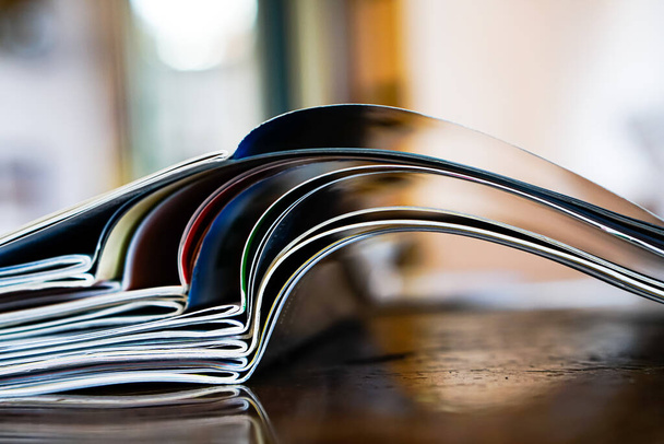 Closeup background of a pile of old magazines with bending pages - Photo, Image