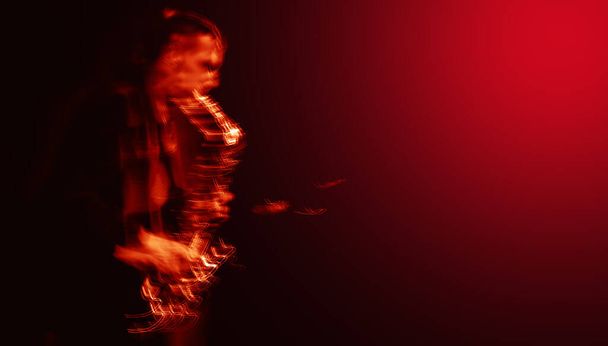 Jazz music concept.  Abstract motion blurred image of saxophone player performing on stage. Sax player going crazy. Image in trendy neon colors. - Fotoğraf, Görsel