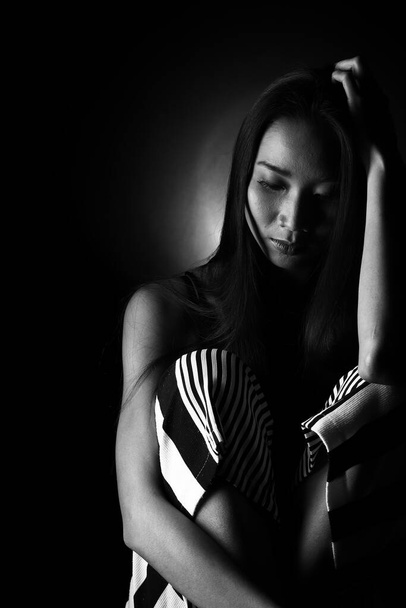 Retrato de Slim Asian Woman black straight hair, Abstract high low exposure contrast shadow, broken heart lonely lady can cry from falling in love and waiting for love to come back
 - Foto, Imagem