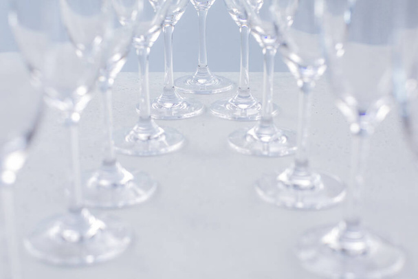 Glasses for champagne on a blue background, glass dishes for drinks side view - Photo, Image