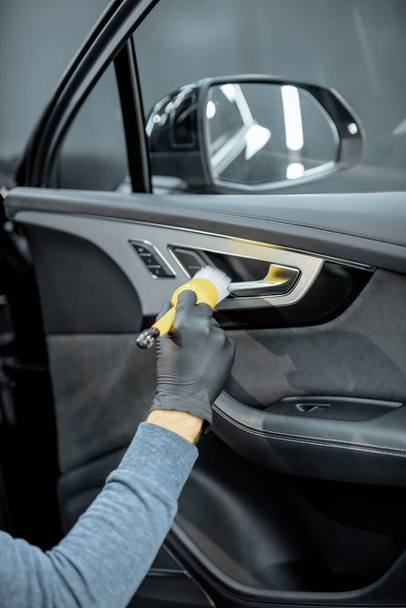 Worker provides professional car interior cleaning - Fotoğraf, Görsel