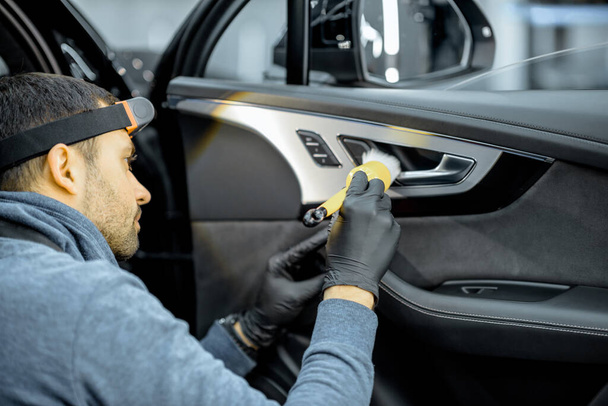 Worker provides professional car interior cleaning - Foto, Bild