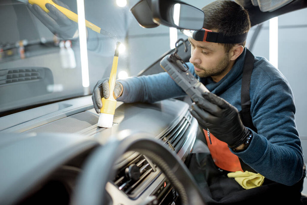 Trabajador proporciona limpieza interior del coche profesional
 - Foto, imagen