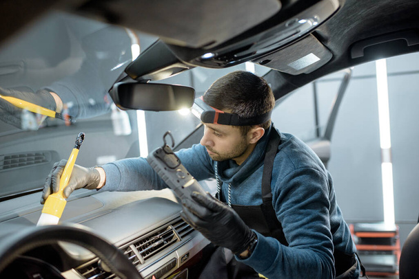 Trabajador proporciona limpieza interior del coche profesional
 - Foto, imagen