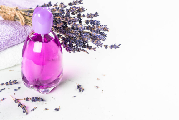 Lavender perfume bottle on white table. - Φωτογραφία, εικόνα