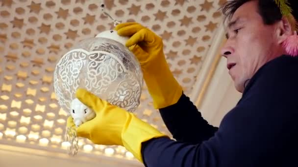 Electrician is finishing install classic bulb into lantern changing light bulbs - Footage, Video