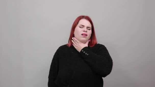 unhappy woman is suffering from a sore throat for possible cold or flu - Záběry, video