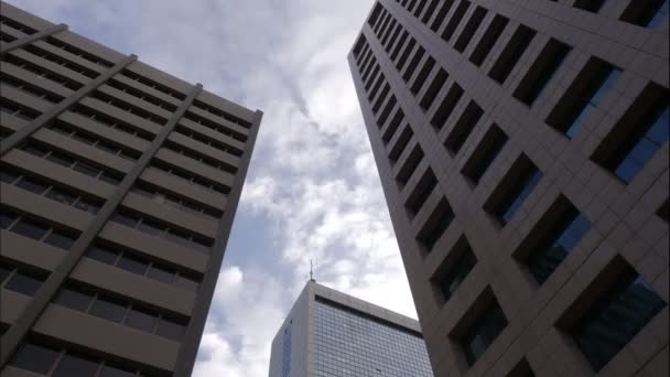 4K UHD Motion time-lapse of buildings in business district, cloud with blue sky ,moving cloud. Financial economy, construction industry ,Business and development concept, Reflections Of Office Tower - Footage, Video