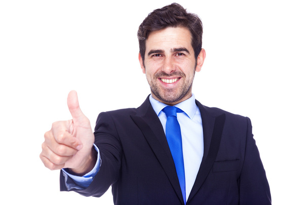 Smiling handsome businessman gesturing thumb up, isolated on a w - Fotoğraf, Görsel