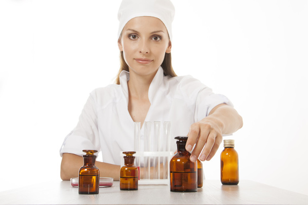 Woman doctor with medication in glass bottles - Фото, изображение