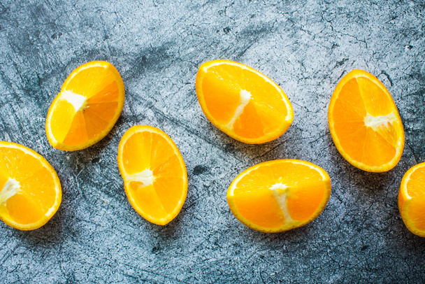 Fresh bright orange slices close up on a gray textured background - Fotoğraf, Görsel