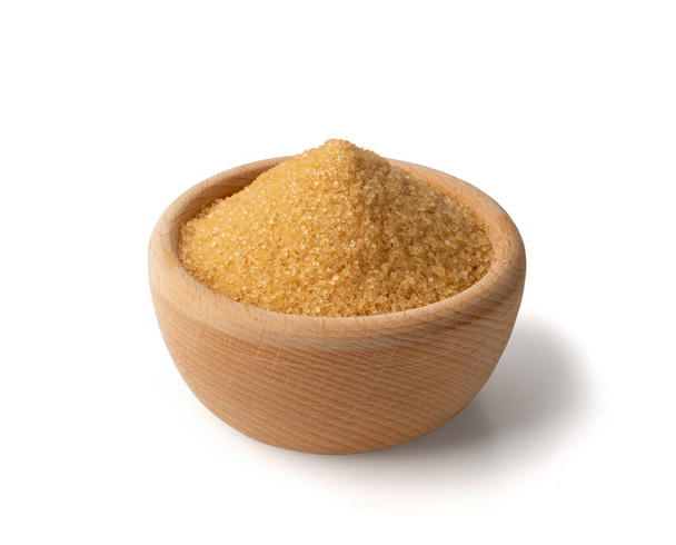 Pile of brown sugar in wood bowl isolated on white background. Raw unrefined cane sugar heap side view - Photo, Image