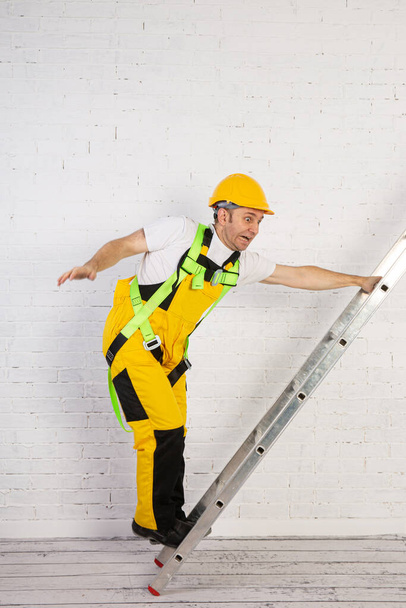 Irresponsible use of a ladder during construction works. - Fotografie, Obrázek