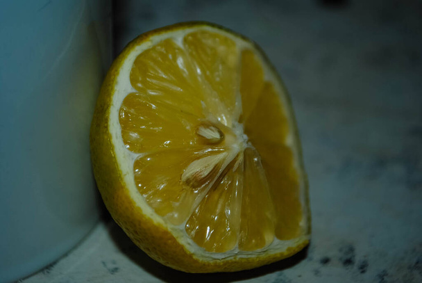 Close-up of the half lemon. Lemon sliced in half. Dry lemon. Lemon with seeds - Photo, Image