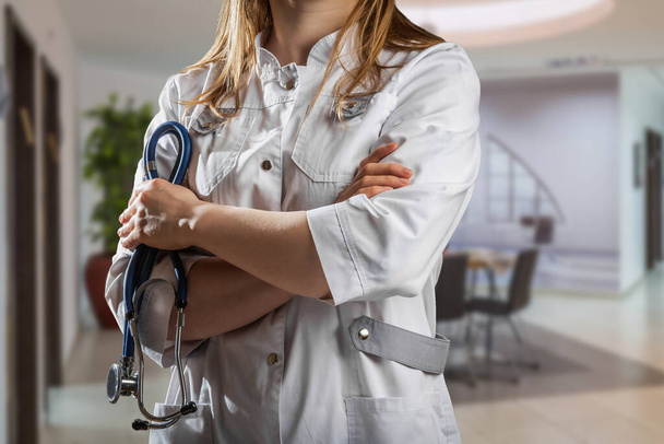 Healthcare and medical concept. Medicine female doctor with stethoscope in hand at the hospital. - Photo, Image