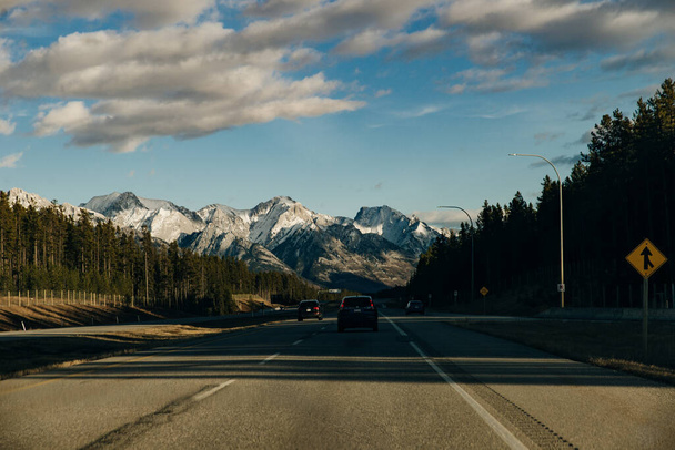 Scenic road through the Canadian Rockies, surrounded with rocky mountains. Taken in Banff National Park, Alberta, Canad. - 写真・画像