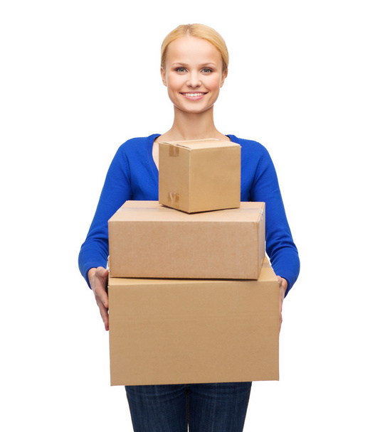 Smiling woman in casual clothes with parcel boxes - Fotó, kép