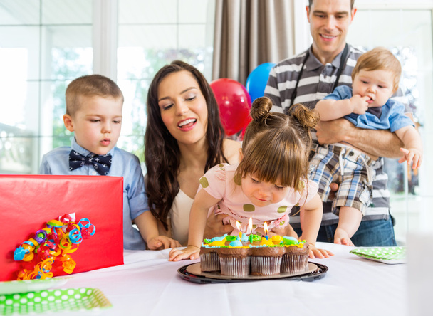 Girl Blowing Out Candles On Birthday Cake - Foto, imagen