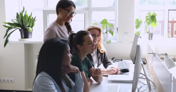 Happy diverse employees looking at monitor, discussing project results. - Footage, Video