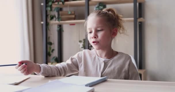 Funny school child girl studying alone feeling bored or tired - Materiał filmowy, wideo