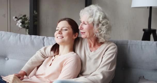 Happy serene grandmother and grown granddaughter bonding at home - Filmagem, Vídeo