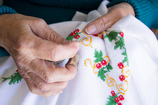 Close-up of woman's hand stitching  - Valokuva, kuva