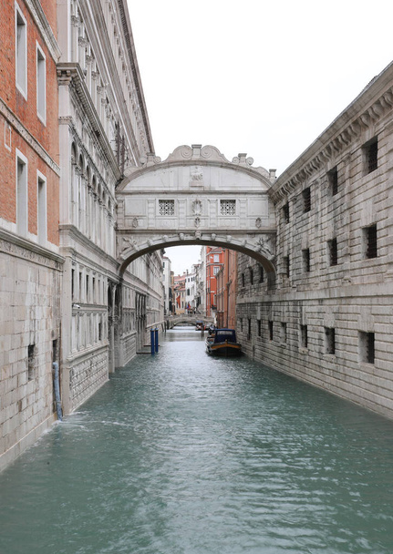 bridge of sighs in Venice Italy without people and navigable canal with a boat - Photo, Image