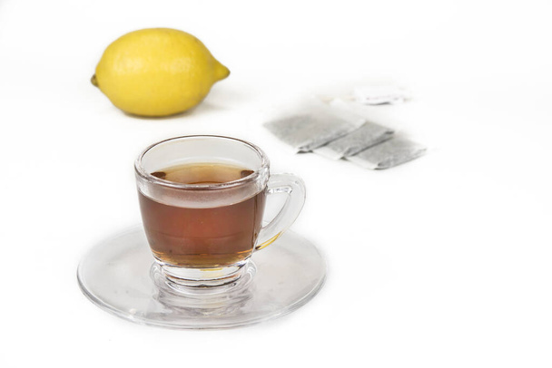 Cup of tea with whole lemon on the white - Φωτογραφία, εικόνα