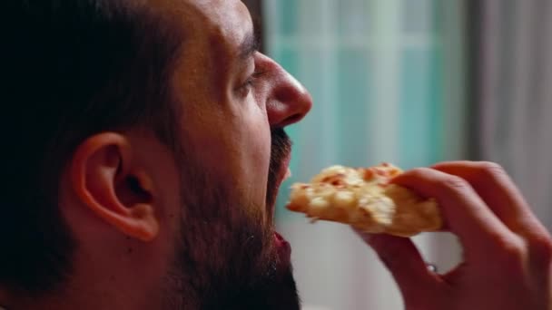 Close up of entrepreneur eating a slice of pizza - Footage, Video