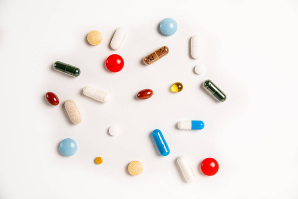 multicolored pills on a white background - Fotó, kép