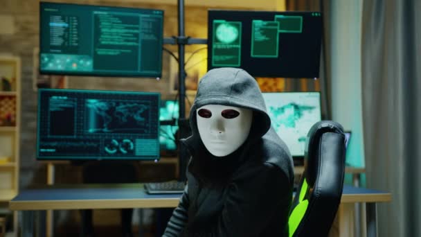 Masked hacker wearing a hoodie to hide his identity - Záběry, video