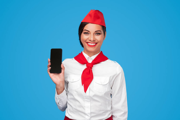 Happy Hispanic stewardess advertising airline app - Valokuva, kuva