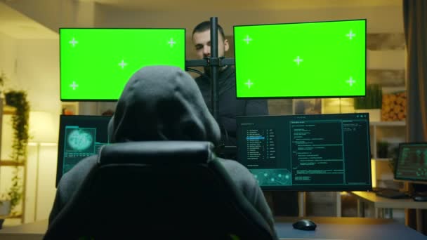 Team of hackers using computer with green screen mockup - Felvétel, videó