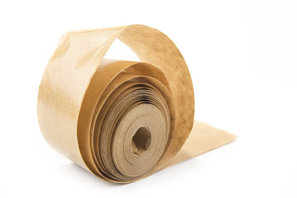 Brown roll of old paper tape for office  on the white - Photo, Image