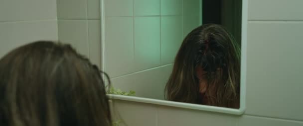 Genç bir kadın aynaya bakıyor, yüzünü yıkıyor, başı ve burnu kanıyor. Korku cinayeti canavar konsepti. Kapat şunu, sinematik. BMPCC 4K - Video, Çekim
