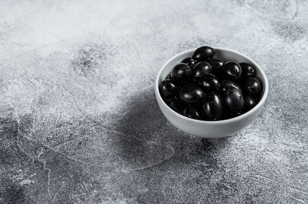 Seedless black olives. Gray background. Top view. Space for text. - Φωτογραφία, εικόνα
