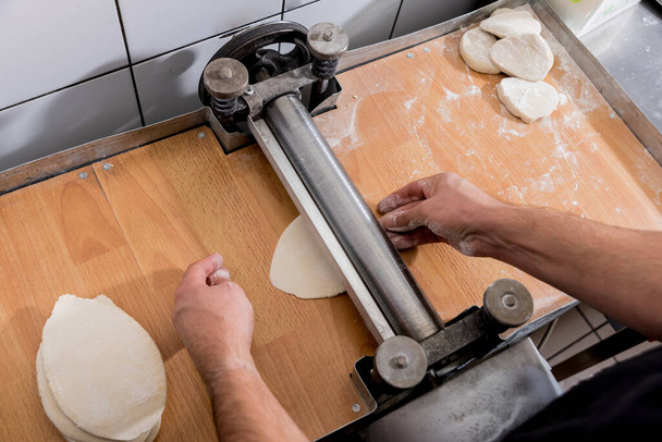 Chef preparing dough for pastry, dumplings, italian pasta or japanese wontons.  - Φωτογραφία, εικόνα