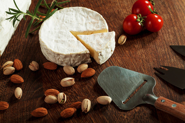 Expensive elite cheese on a wooden background - Foto, Bild