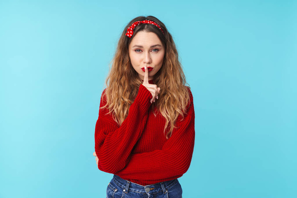 Image of beautiful young woman in headband showing silence gesture isolated over blue background - Фото, зображення