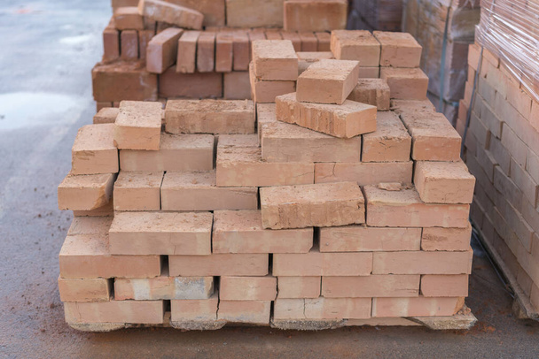 clay brick stored for building construction. Industrial production of bricks. brick production line in factory, stacked bricks. - Photo, Image