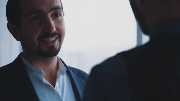Male business workers are discussing issues. Copy space. Blurred forefront. Everything is alright Blurred background. Close up. 4K. - Materiał filmowy, wideo