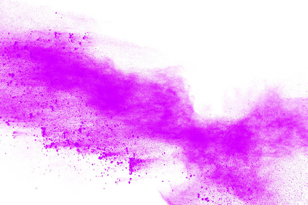 Purple particles explosion on white background. Freeze motion of purple dust splash on background. - Photo, Image