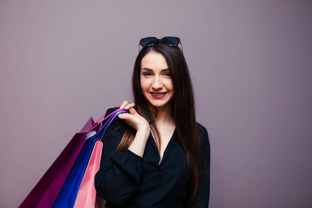 Young happy summer shopping woman with shopping bags isolated on background. - Fotó, kép