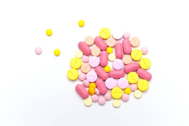 Prescription drugs, pills, capsules and tablets of different colors all mixed in. On white background. Top view. - 写真・画像