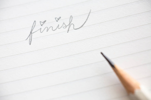 Hand writing " Finish " on white paper background, Close up & Macro shot, Selective focus, Stationery concept - Foto, Bild