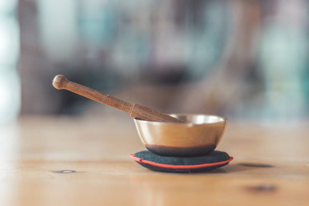 Small singing bowl on a rustic wooden table  - Φωτογραφία, εικόνα