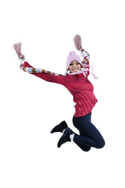 Woman in winter clothing jumping - Fotó, kép