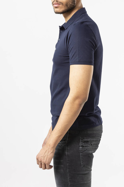 a man in a blue Polo shirt on a white background, a shirt with a place for the inscription, copy space - Foto, Imagem